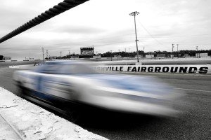 A race car is a blue-and-white blur as it zooms past at historic Nashville Fairgrounds Speedway on a late October Saturday when drivers were running practice laps and testing their cars a week before the All American 400 race. / Photo by Bill Hobbs Photography billhobbs.com
