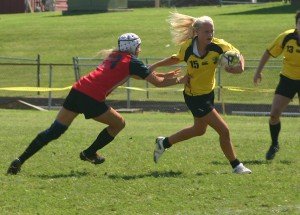 A Nashville Stone Lion gives a stiff arm as she breaks through a tackle attempt. / Photo by Matthew Maxey