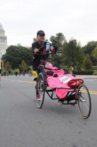 Heath White pushing Gaby Conklin in the pair's first marathon, the Marine Corps Marathon in Washington D.C. Saturday they will do the St. Jude Country Music Marathon together.