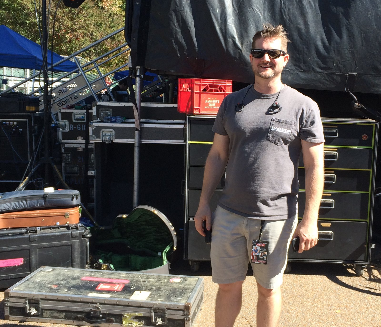 Harbor Entertainment founder and event producer Drew Dedo stands behind the stage he and his team put into place on Savannah's Main Street. PHOTO BY STEVE MORLEY